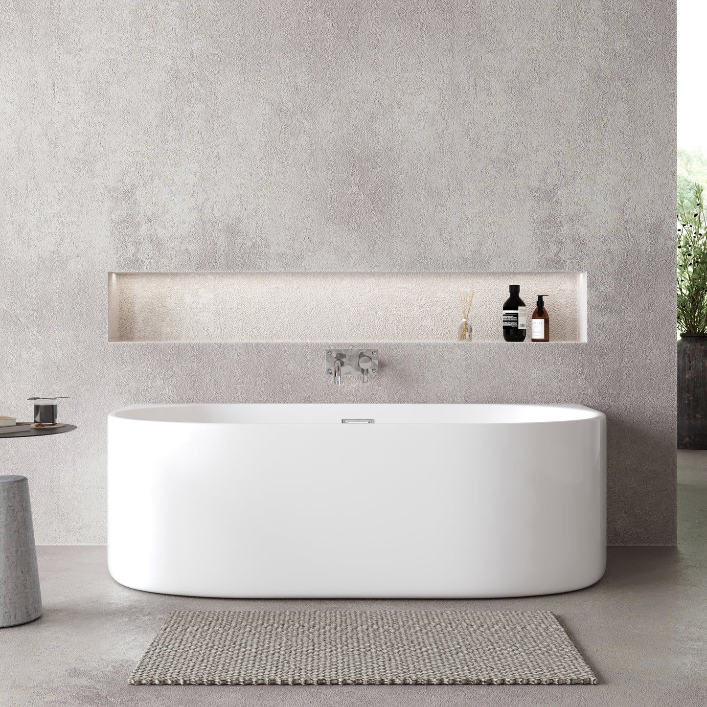 A white, double-ended, back-to-wall curved bath in a modern bathroom setting with a central waste position.