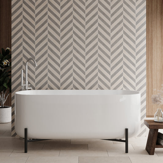 A freestanding white acrylic bath with an elevated stand, positioned in a bathroom with patterned wall tiles.