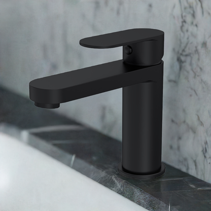 A black, contemporary basin mixer tap with a curved design, mounted on a bathroom sink with a push button waste system.