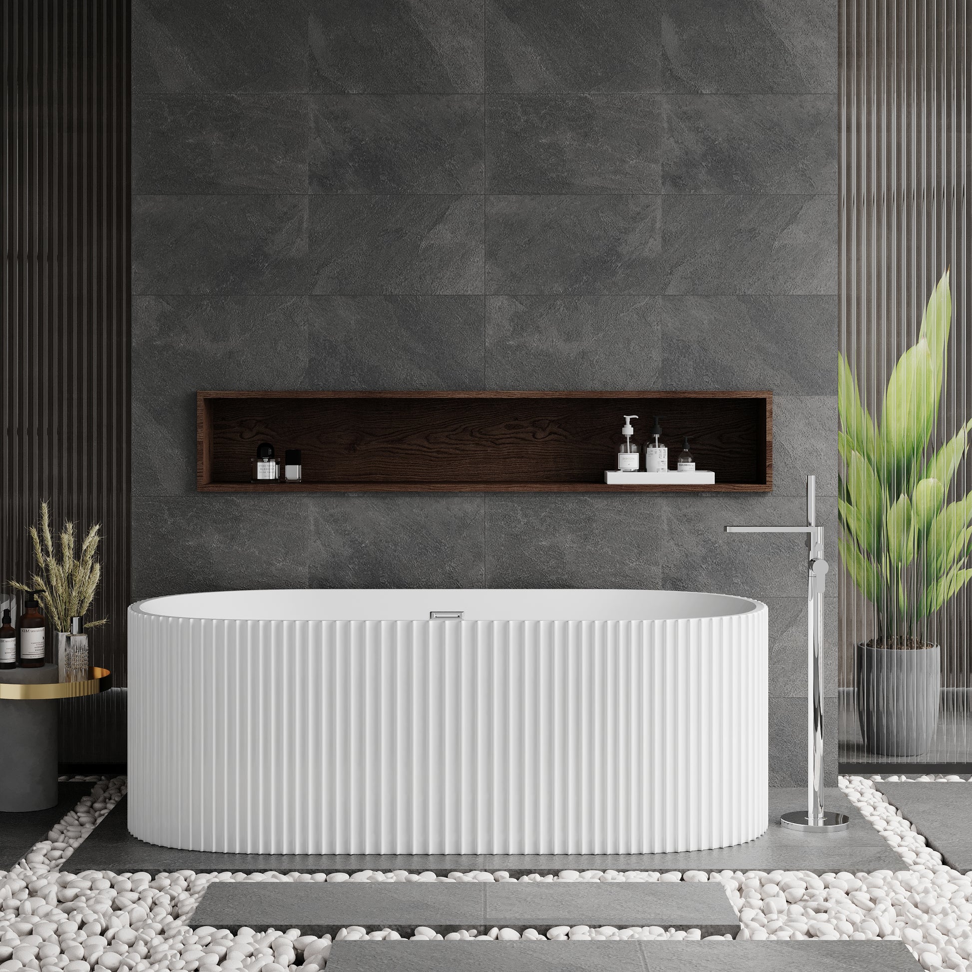 A freestanding white oval bathtub with a fluted design, situated in a bathroom with dark gray walls and a central shelf above the tub featuring toiletries.