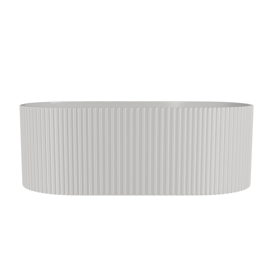 A freestanding white oval bathtub with a fluted design.