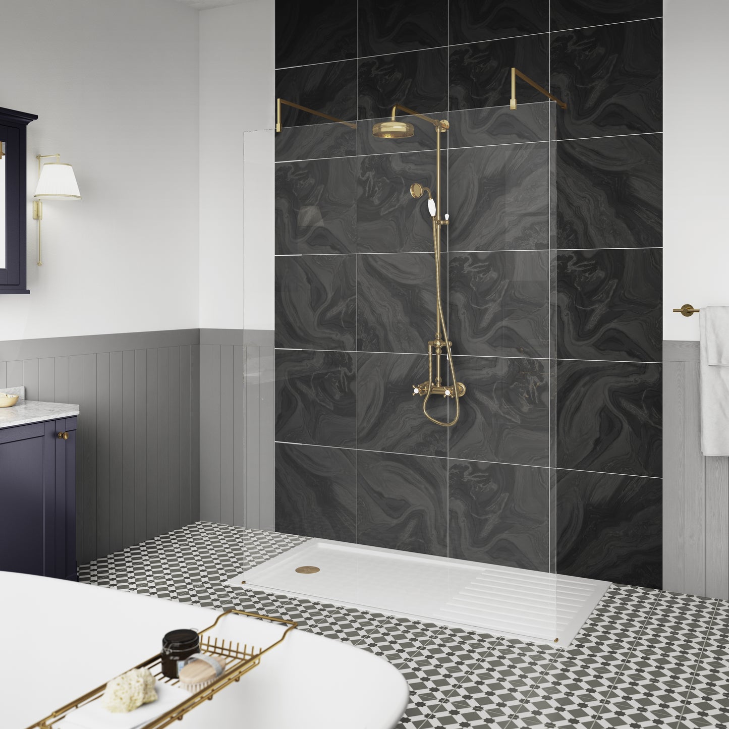 Image shows a bathroom with black marble wall tiles, a traditional thermostatic shower valve and kit with a round shower head, matching handset, and a diverter, finished in brushed brass.